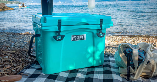 25 Quart Viva Cubix cooler and tumbler on a picnic blanket by the sea