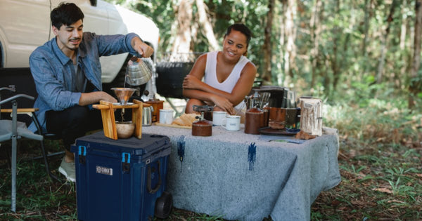 People using a 46 Quart Cubix cooler on a camping trip